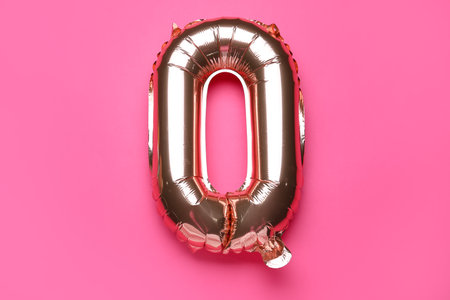 Balloon in shape of letter O on pink backgroundの写真素材