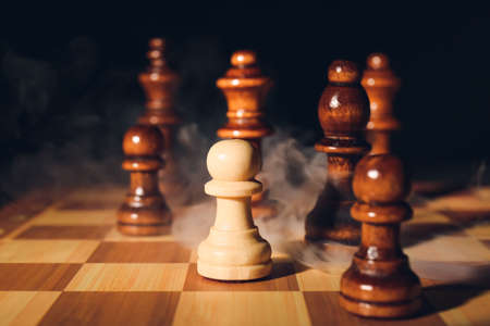 Game board with chess pieces on dark backgroundの写真素材