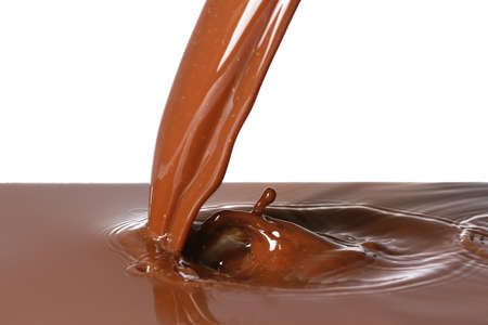 Pouring of hot chocolate on white backgroundの写真素材