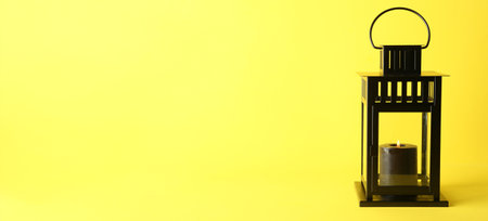 Beautiful Christmas lantern with burning candle on yellow background with space for text