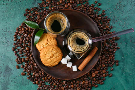 Pot and cup with delicious turkish coffee and cookies on color backgroundの写真素材