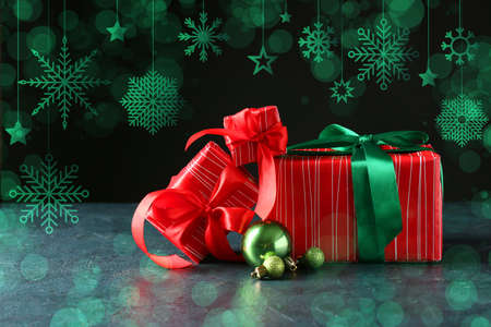Stylish Christmas gifts with balls on dark background