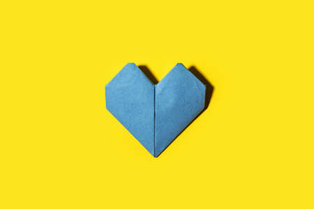 Origami heart on color backgroundの写真素材