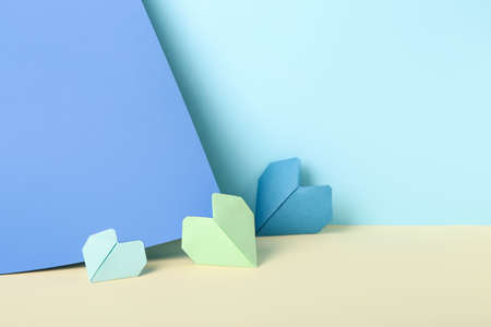 Origami hearts on color backgroundの写真素材