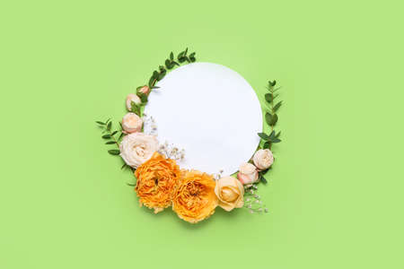 Empty card with fresh flowers on color background