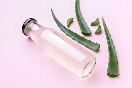 Bottle of healthy aloe juice on color backgroundの写真素材
