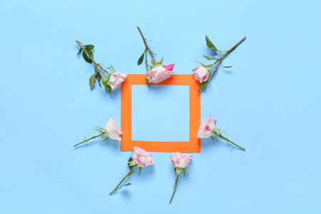 Beautiful flowers and blank frame on color backgroundの写真素材