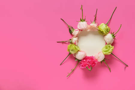 Beautiful flowers and blank card on color backgroundの写真素材