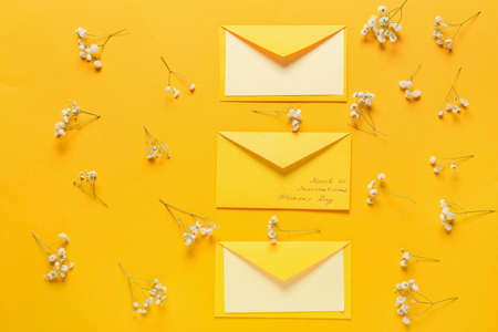 Beautiful composition with envelopes or International Women's Day on color backgroundの写真素材