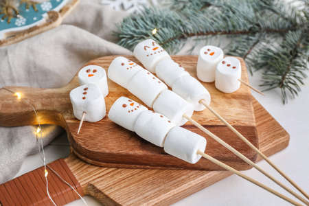 Snowmen made of soft marshmallows on tableの写真素材