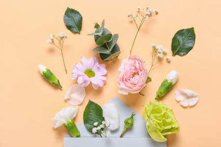 Beautiful composition with envelope and flowers on color backgroundの写真素材