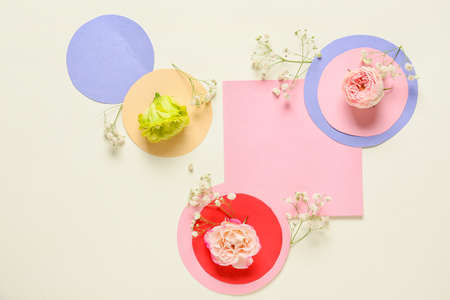 Beautiful composition with blank card and flowers on light backgroundの写真素材