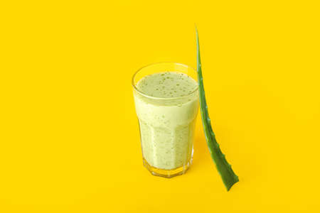 Glass of healthy aloe juice on color backgroundの写真素材