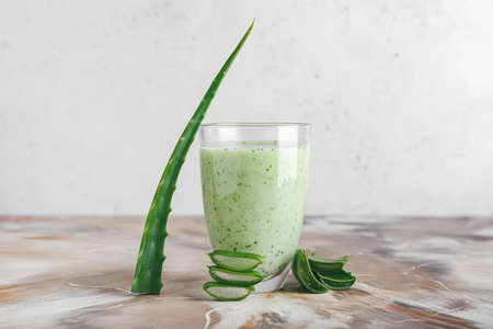 Glass of healthy aloe juice on grunge backgroundの写真素材