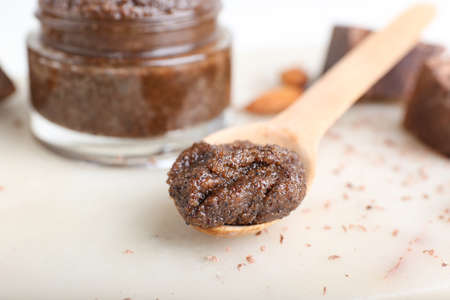 Jar of chocolate body scrub and ingredients on light backgroundの写真素材