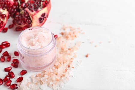 Composition with body scrub, sea salt and pomegranate on light backgroundの写真素材