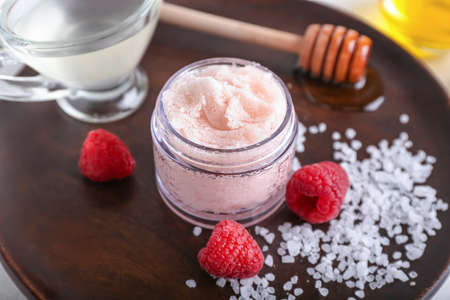 Plate with raspberry body scrub and ingredients on tableの写真素材