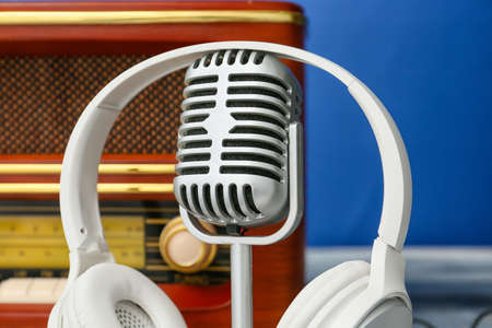 Microphone and headphones with retro radio receiver on color background, closeupの写真素材