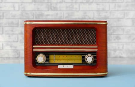 Vintage radio receiver on table in roomの写真素材