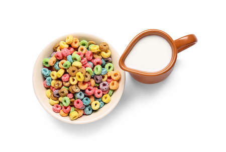 Bowl with cereals and jug of milk on white backgroundの写真素材