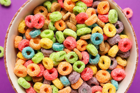 Bowl with tasty cereal rings on color background, closeupの写真素材