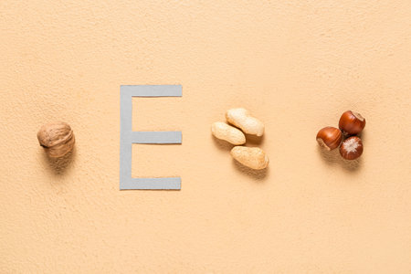 Letter E with different nuts on color backgroundの写真素材