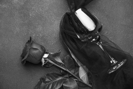 Beautiful rose and glass on dark backgroundの写真素材