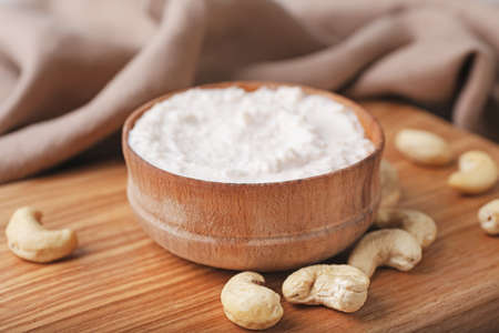 Bowl with cashew sour cream and nuts on table, closeupの写真素材