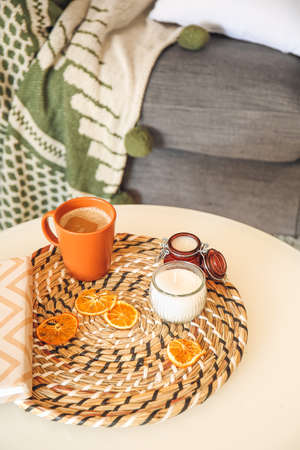 Aroma candles with cup of coffee on table in roomの写真素材
