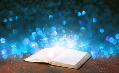 Open magic book on dark color backgroundの写真素材