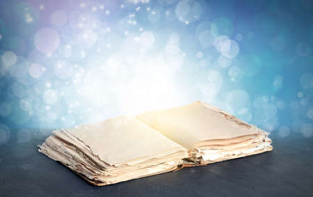 Open magic book on color background