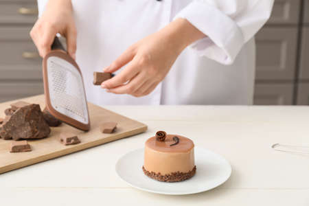 Woman and tasty cake in kitchenの写真素材