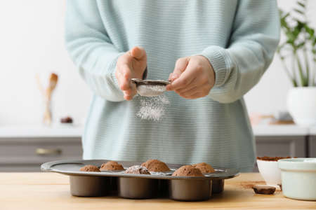 Woman cooking cupcakes in kitchen, closeupの写真素材