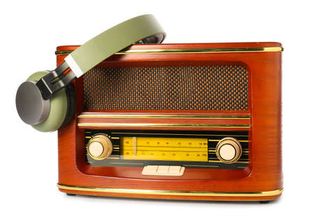 Retro radio receiver with headphones on white backgroundの写真素材