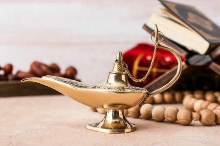 Aladdin lamp of wishes and tasbih on table