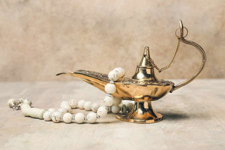 Aladdin lamp of wishes and tasbih on gray backgroundの写真素材