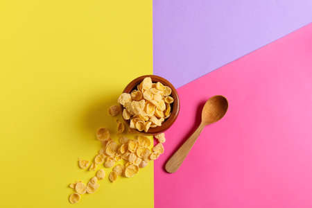 Bowl with tasty cornflakes on color backgroundの写真素材