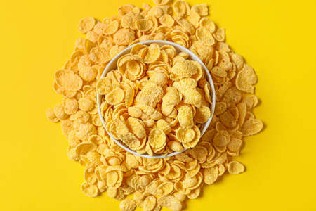 Bowl with tasty cornflakes on color backgroundの写真素材