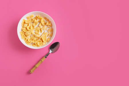 Bowl with tasty cornflakes on color backgroundの写真素材