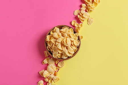 Bowl with tasty cornflakes on color backgroundの写真素材