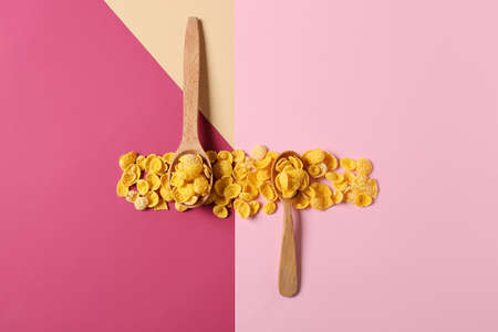 Spoons with tasty cornflakes on color backgroundの写真素材