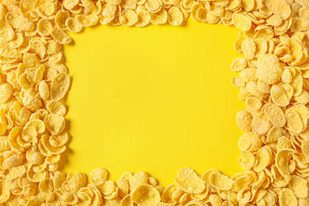 Frame made of tasty cornflakes on color backgroundの写真素材