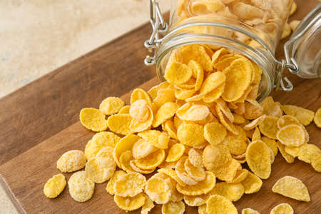 Jar with tasty cornflakes on wooden backgroundの写真素材