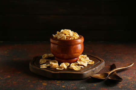 Bowl with tasty cornflakes on grunge backgroundの写真素材