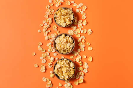Bowls with tasty cornflakes on color backgroundの写真素材
