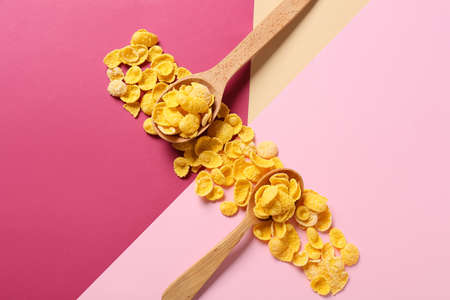 Spoons with tasty cornflakes on color backgroundの写真素材