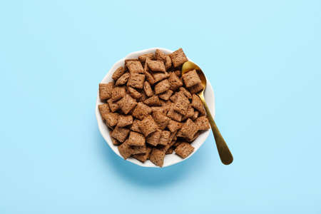 Bowl with tasty corn pillows on color backgroundの写真素材