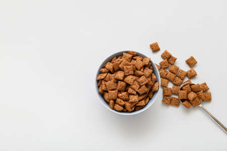 Bowl with tasty corn pillows on light backgroundの写真素材