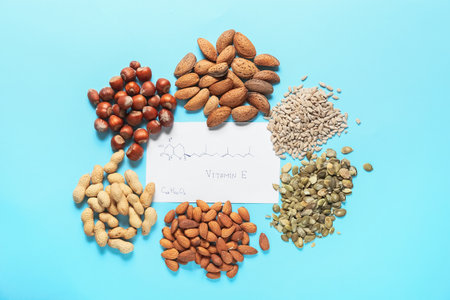 Structural formula of vitamin E and different healthy nuts with seeds on color background