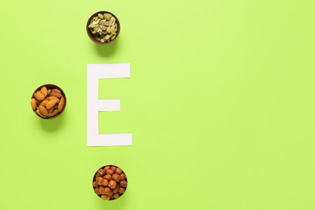 Letter E with healthy nuts and seeds on color backgroundの写真素材